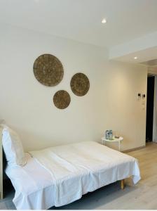 a bedroom with a white bed and two mirrors on the wall at Riviera in Cagnes-sur-Mer