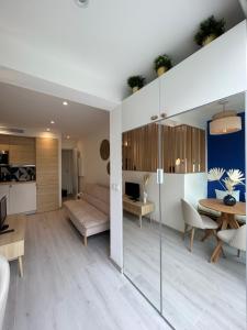 a living room with a couch and a table at Riviera 1 ou Riviera 2 ou réservez les 2 Front de Mer Cagnes sur Mer Promenade de la plage in Cagnes-sur-Mer