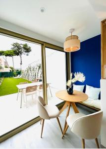 a living room with a table and chairs at Riviera in Cagnes-sur-Mer