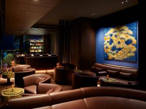 a waiting room with couches and a painting on the wall at Mitsui Garden Hotel Nihonbashi Premier in Tokyo