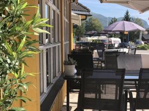 a group of tables and chairs outside of a building at Grong Hotell in Grong