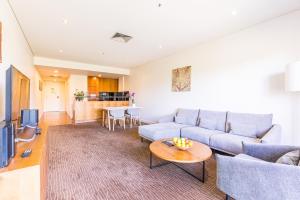 a living room with a couch and a table at Seasons Botanic Gardens in Melbourne