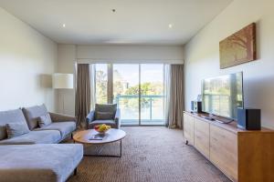 a living room with a couch and a tv at Seasons Botanic Gardens in Melbourne