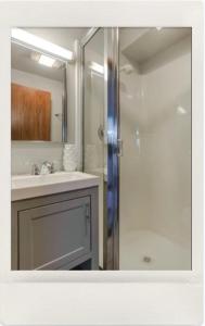 a bathroom with a shower and a sink and a mirror at Private Guest Suite in West Bellevue Home in Bellevue