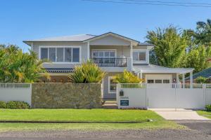 a white fence in front of a house at Orana in Byron Bay