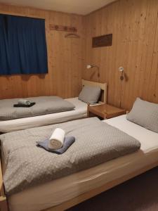 a room with three beds with hats on them at Freude am Berg in Malix