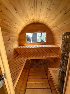 a small wooden sauna with a window in it at itotoi 糸島 in Itoshima