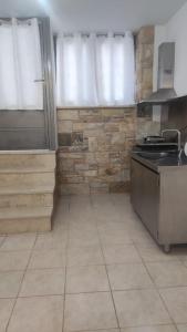 a kitchen with a sink and a stove in it at Nektar-apartments in Piraeus