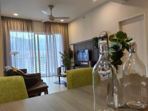 a living room with a table with two glass bottles on it at Windmill Upon Hills, Genting Highlands in Genting Highlands