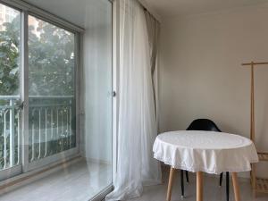 a room with a table and a large window at Haeng Un - For Foreigner & Female Only in Suwon