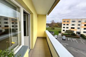 a balcony with a view of a parking lot at Only 5 min. From Tallinn Airport in Petrikyula
