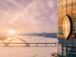 a view of a river with a building and a bridge at InterContinental Changsha by IHG in Changsha