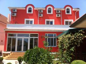 a red house with white windows and a red at Villa Favorita in Eforie Sud