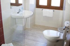 a bathroom with a sink and a toilet at Hotel Lupa in San Juan de Piñera