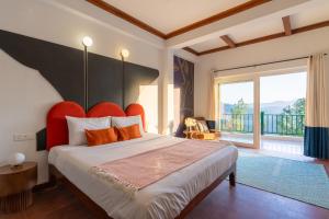 a bedroom with a large bed with an orange headboard at Seclude Kasauli, Himachal Pradesh in Kasauli