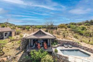 an aerial view of a house with a swimming pool at Zulu Rock Lodge - Babanango Game Reserve in Ulundi