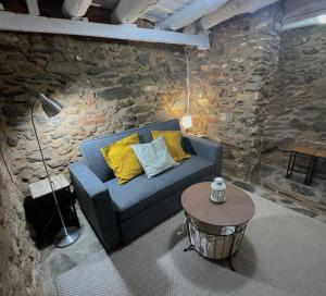 a living room with a blue couch and a table at Tinoquero VTAR in Fuenteheridos