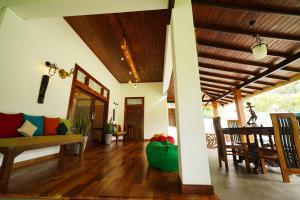 a living room with a couch and a table at Cozy Villa in Hikkaduwa