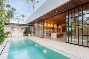 an indoor swimming pool in the middle of a house at The Dreamland by The Young Villas in Uluwatu