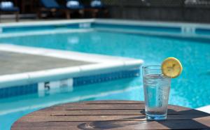 a drink on a table next to a swimming pool at The Harbor Front Inn in Greenport