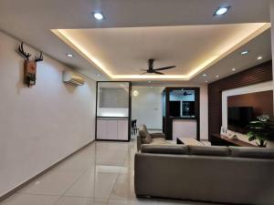 a living room with a couch and a ceiling at Permas 14min to MidValley 10pax WiFi TV Box 4BRoom in Johor Bahru
