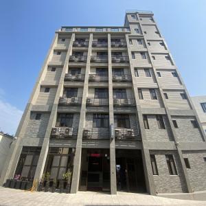 a tall building with balconies on the side of it at Zhuluowan Club in Nangan