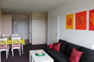 a living room with a black couch and a table at Ferienwohnung E510 für 2-4 Personen an der Ostsee in Brasilien