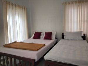 Guestland Homestay客房内的一张或多张床位