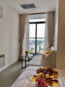 a hotel room with a bed and a large window at The Penthouse in Phnom Penh