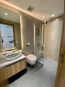 a bathroom with a toilet and a sink and a shower at The Penthouse in Phnom Penh