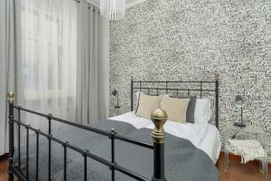 a bedroom with a bed and a brick wall at Sunny Apartments in the Heart of Poznań Old Town by Renters in Poznań
