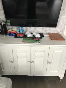 a white cabinet with a tv on top of it at Sun Villa Thanh Liên Wyndham Vườn Vua Resort & Villas in Ðồng Phú