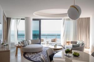 a living room with a view of the ocean at Jumeirah Saadiyat Island Abu Dhabi in Abu Dhabi