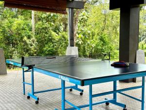 a ping pong table sitting on a patio at The Wooden Retreat by Elite Stay in Port Dickson