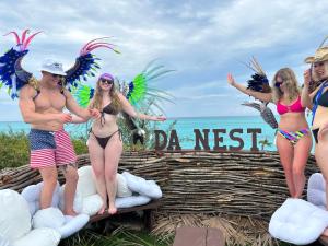 a group of people in bikinis on the beach at #6 Ferguson Rd - Townhouse in Nassau