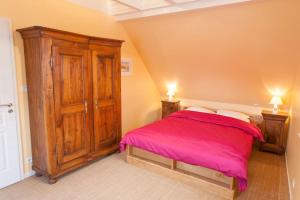 a bedroom with a bed and a wooden cabinet at Doller Villa 4 stars Hot Tub Mountain Ski Ballon d'Alsace in Sewen