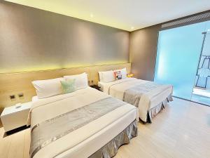 Rúm í herbergi á Vasty Jiaoxi Hotel