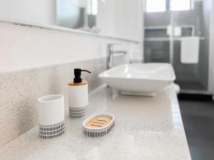 a bathroom with a sink and a counter with a bottle of soap at Sanoa Residence - Spacious Villa with infinity pool in Grand Baie +23 photos