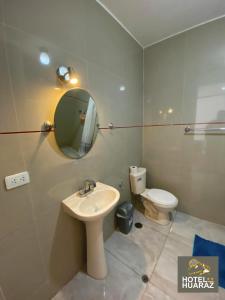 a bathroom with a sink and a toilet at HOTEL HUARAZ in Tacna