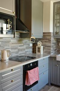 a kitchen with a stove with a towel on the oven at Rose Blossom apartment in Paris in Vanves