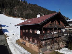 a large wooden building in the snow on a mountain at Loya Chalet WILD32 in Oberau