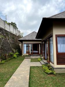 a house with a pathway leading to the front yard at Shankara Munduk Bali in Munduk