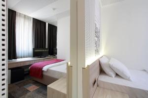 Letto o letti in una camera di Hotel Cosmopolit