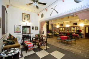 a lobby with chairs and tables in a building at Jaipur Vintage House in Jaipur