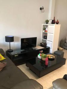 a living room with a couch and a coffee table at 311 Nana’s Homes BBQ, Games, Netflix 11pax in Ampang +32 photos