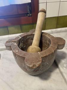 an old pottery bowl with a stick in it at Villa Le Anfore in Imperia