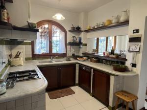 a kitchen with a sink and a stove top oven at Villa Le Anfore in Imperia