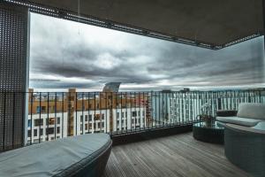 a room with a balcony with a view of a city at Luxury 3BR apartment at CENTRAL OSLO barcode in Oslo