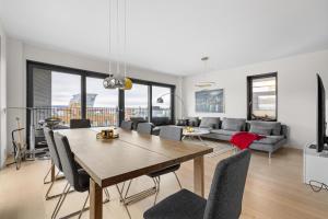 a living room with a wooden table and chairs at Luxury 3BR apartment at CENTRAL OSLO barcode in Oslo