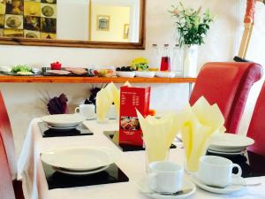 a table with cups and saucers on it at Number 43 in Derry Londonderry